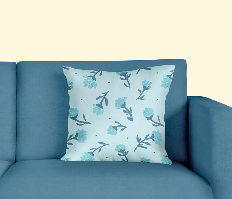 soft blue pillow with blue toss flowers on blue couch